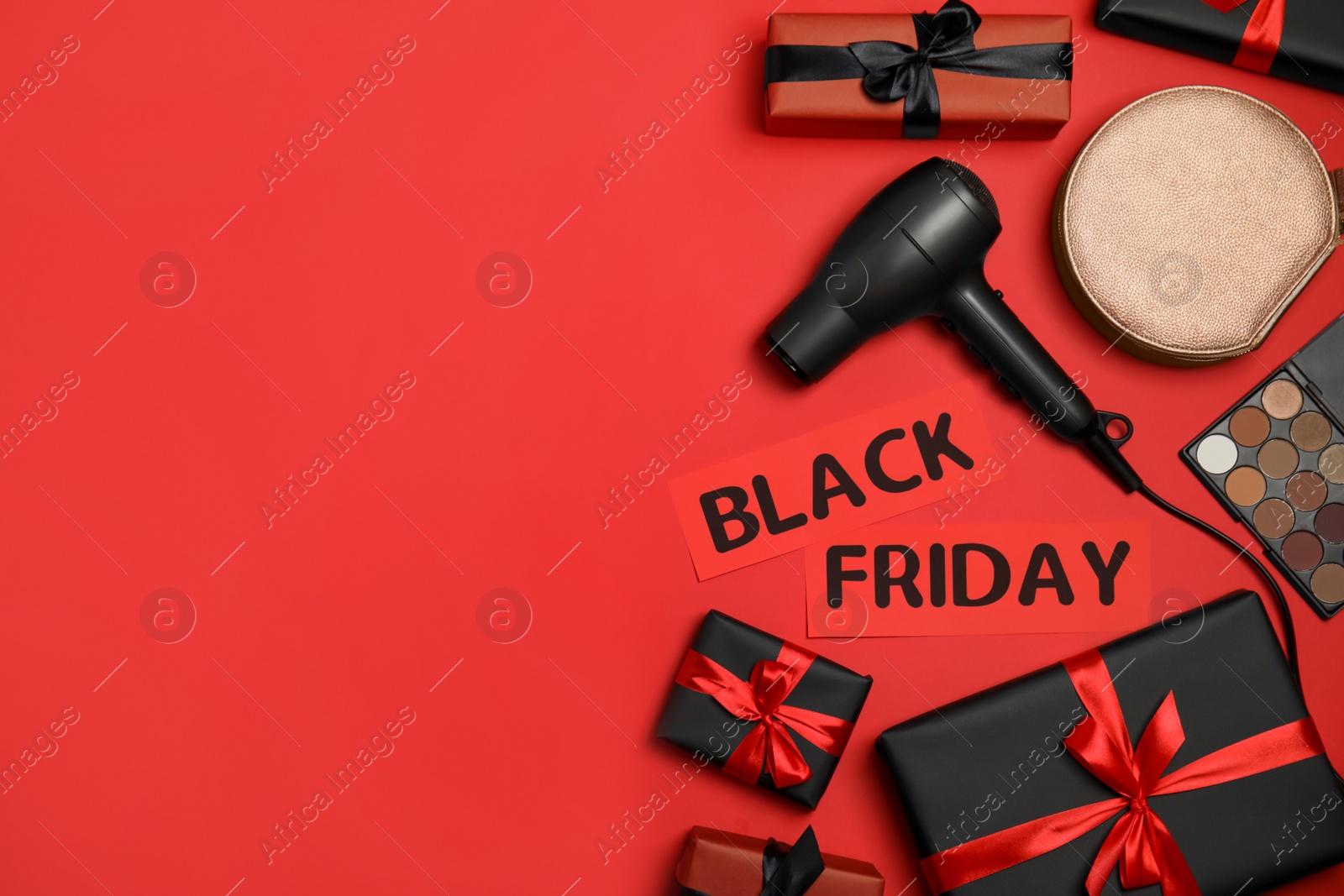 Photo of Gift boxes, cosmetics, bag, hairdryer and phrase Black Friday on red background, flat lay. Space for text