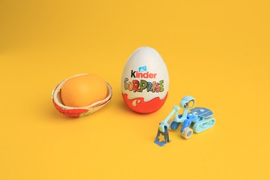 Sveti Vlas, Bulgaria - July 3, 2023: Kinder Surprise Eggs, plastic capsule and toy on yellow background