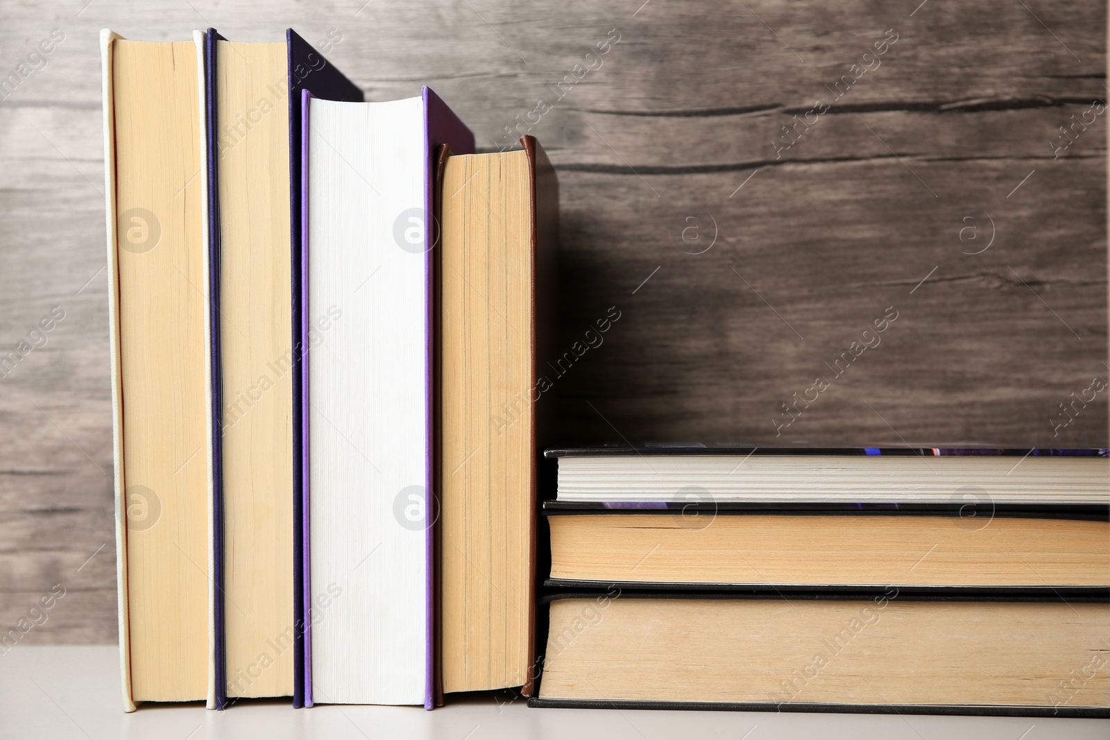 Photo of Collection of different books on white shelf