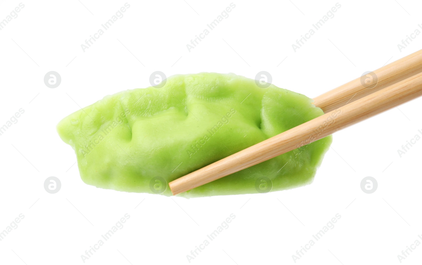 Photo of Chopsticks with tasty green dumpling (gyoza) isolated on white