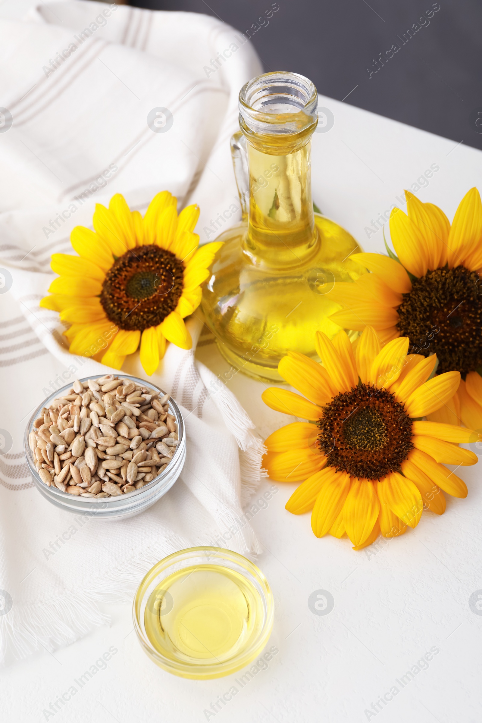 Photo of Composition with sunflower oil on white table, above view