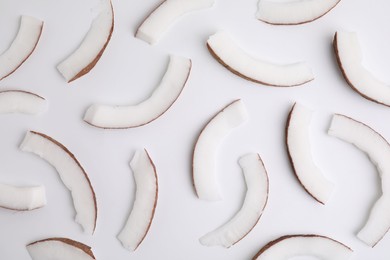 Pieces of fresh coconut on white background, top view