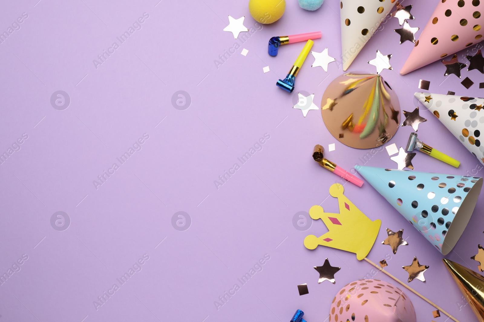 Photo of Flat lay composition with party hats and other festive items on violet background. Space for text