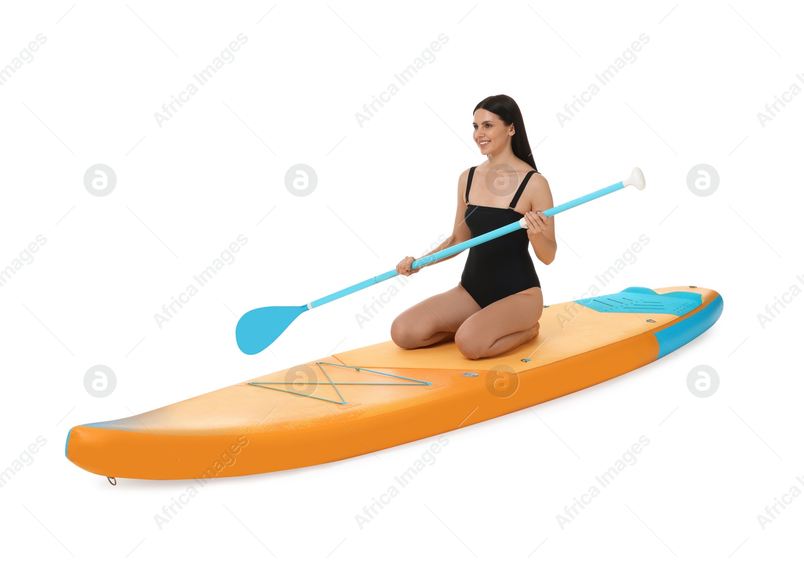 Photo of Happy woman with paddle on orange SUP board against white background