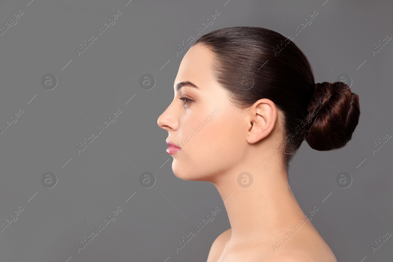 Photo of Portrait of young woman with beautiful face and natural makeup on color background, space for text