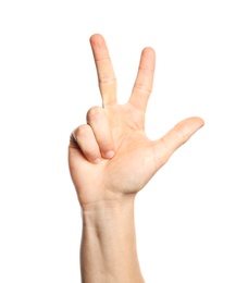 Photo of Man showing number three on white background, closeup. Sign language