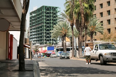 Photo of City street with parked cars and buildings