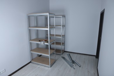 Photo of Office room with white walls and metal storage shelves