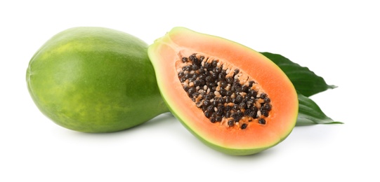 Photo of Fresh ripe papaya fruits with green leaves on white background