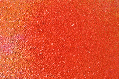 Photo of Orange textured surface as background, closeup view