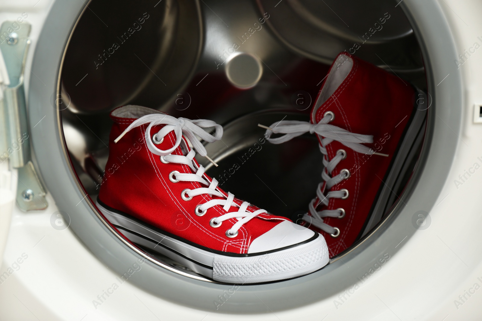 Photo of Clean sports shoes in washing machine drum