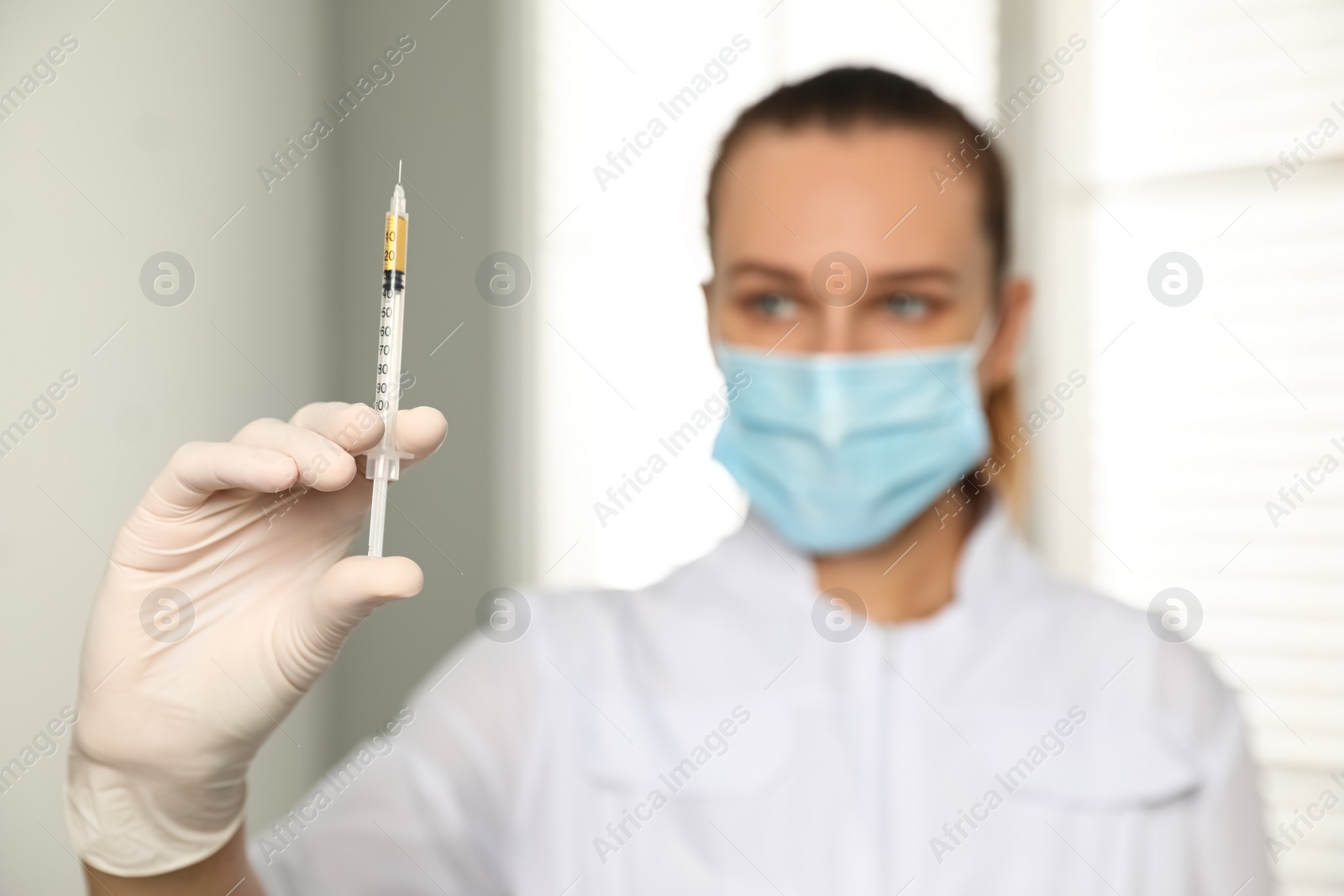 Photo of Doctor with syringe in hospital, focus on hand. Vaccination day