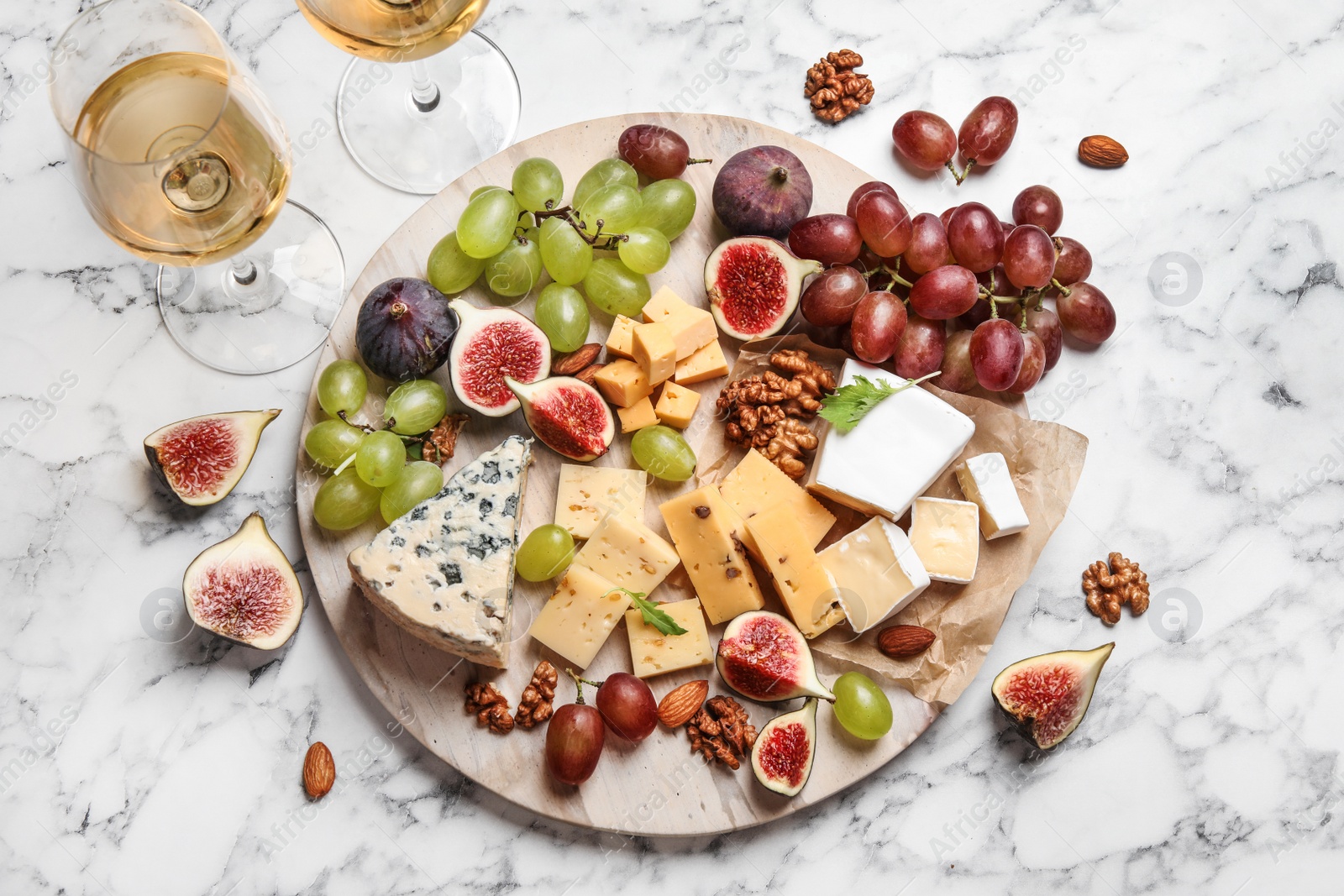 Photo of Set of different snacks with ripe figs served on marble table, flat lay