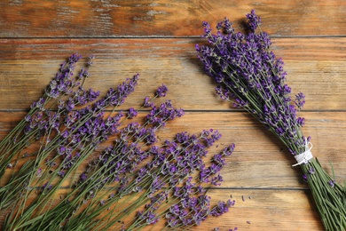 Photo of Beautiful fresh lavender flowers on wooden background, flat lay