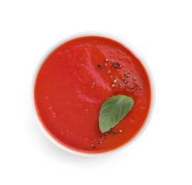 Photo of Delicious tomato soup with basil and spices isolated on white, top view