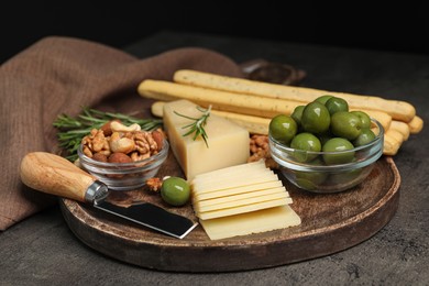 Photo of Snack set with delicious Parmesan cheese on grey table