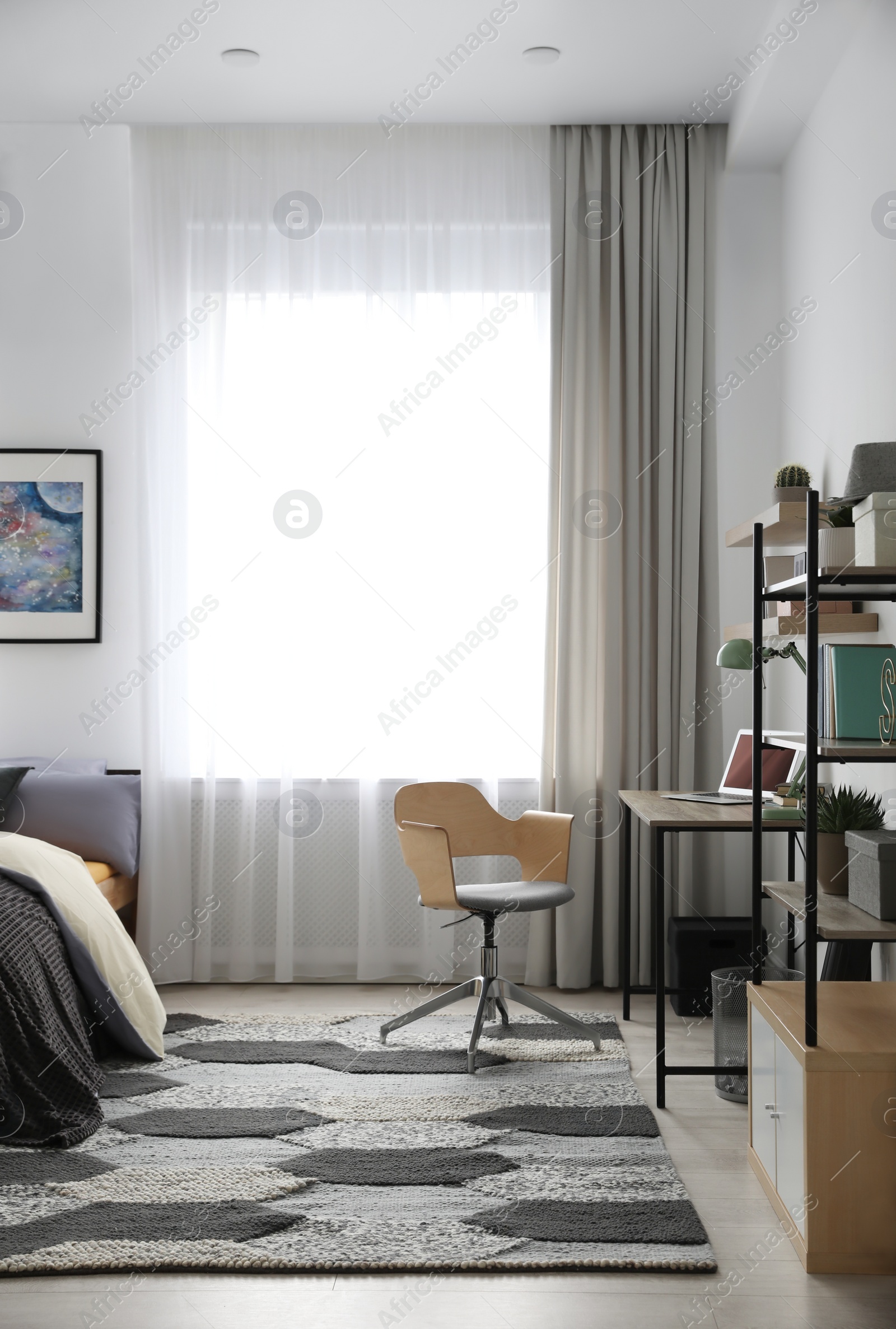 Photo of Modern teenager's room interior with workplace and bed