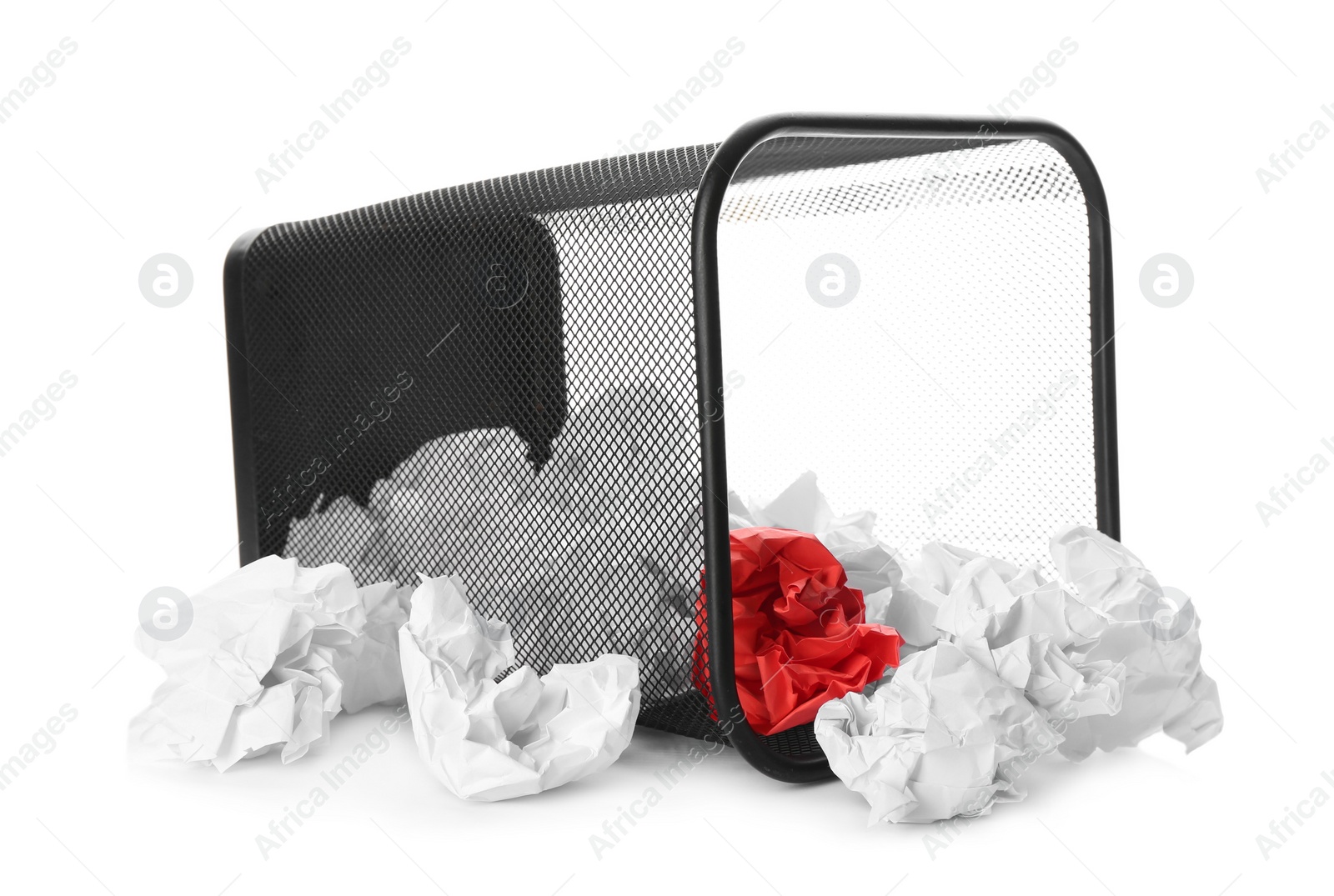 Photo of Basket with scattered crumpled paper balls on white background