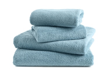 Photo of Stack of clean soft towels on white background