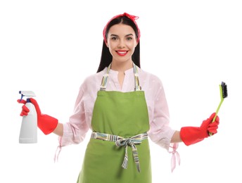 Photo of Young housewife with detergent and brush on white background