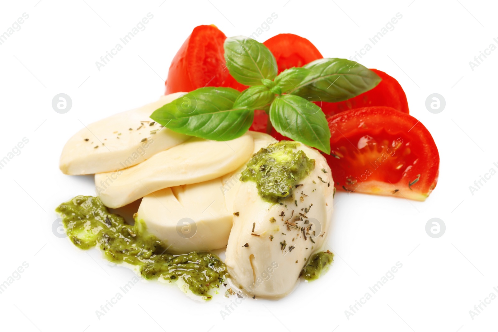 Photo of Tasty salad Caprese with mozzarella, tomatoes, basil and pesto sauce isolated on white