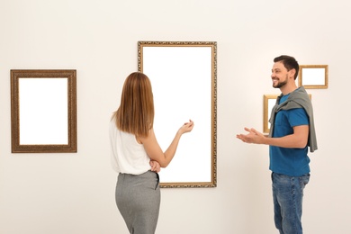 People viewing exposition in modern art gallery