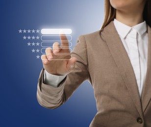 Woman choosing five stars on virtual screen against blue background, closeup. Customer satisfaction score