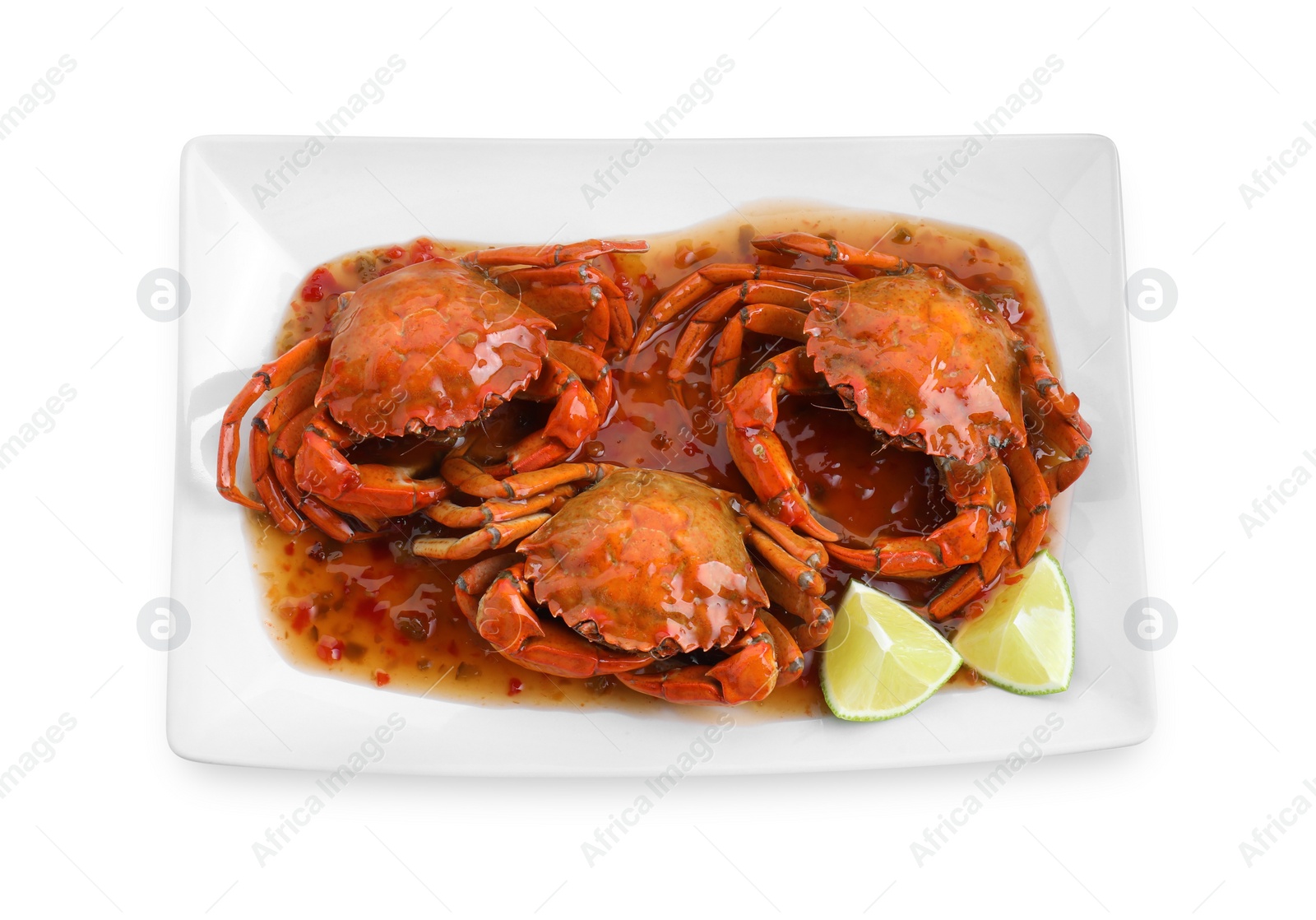 Photo of Delicious boiled crabs with sauce and lime isolated on white, top view