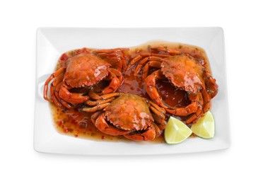 Photo of Delicious boiled crabs with sauce and lime isolated on white, top view