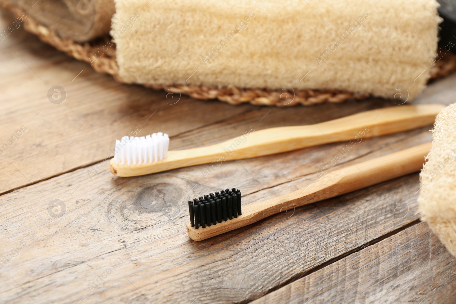 Photo of Toothbrushes made of bamboo on wooden table