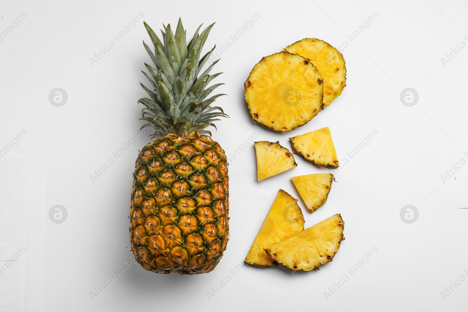 Photo of Composition with raw cut pineapples on white background, top view