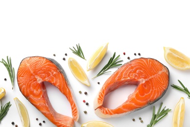 Photo of Fresh raw salmon steaks with rosemary and lemon on white background, top view