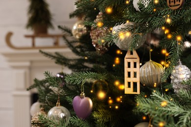 Photo of Beautiful Christmas tree in room, closeup. Space for text