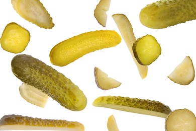 Image of Tasty pickled cucumbers falling on white background