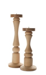 Photo of Two stylish wooden candlesticks on white background