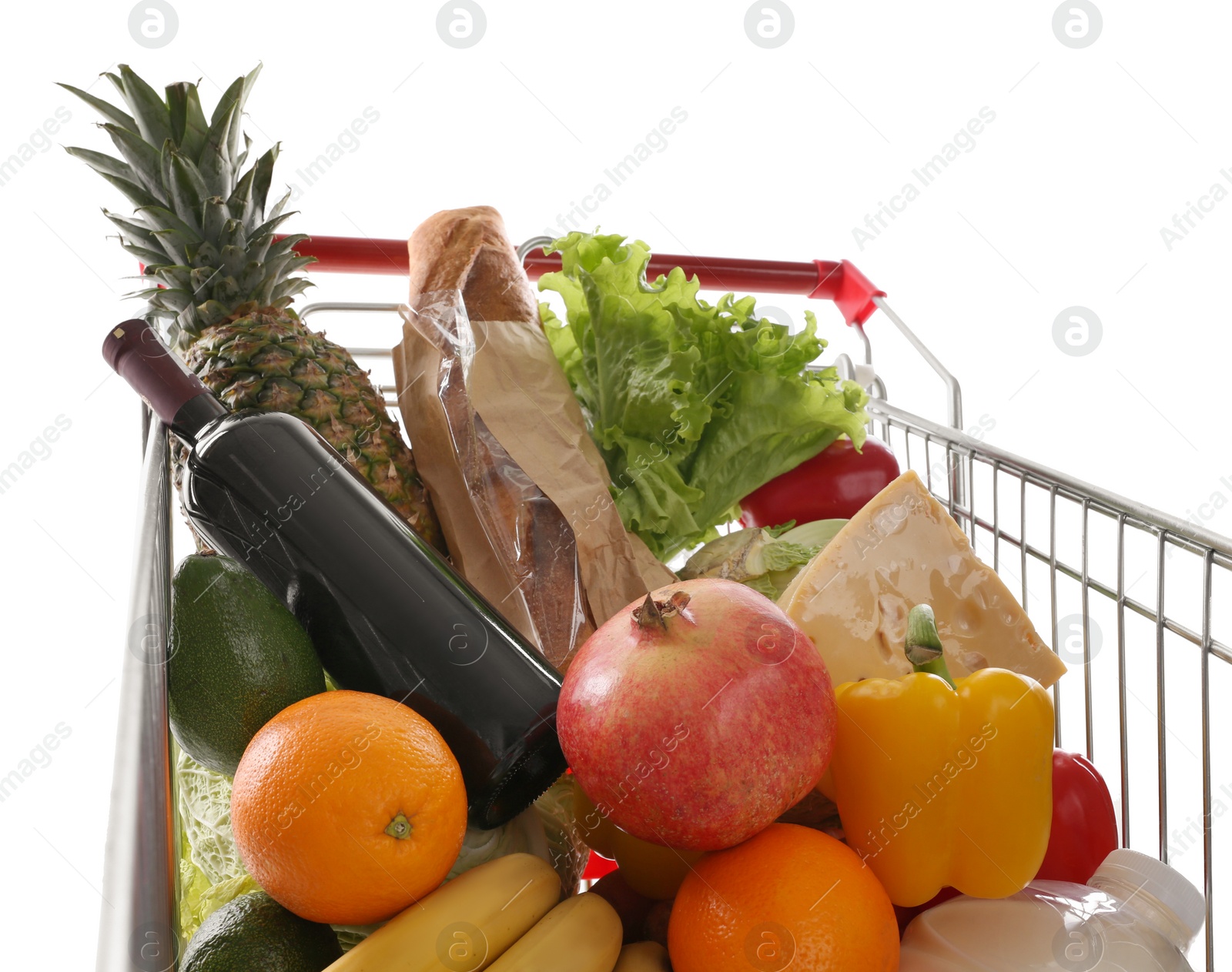 Photo of Shopping cart with groceries on white background, closeup