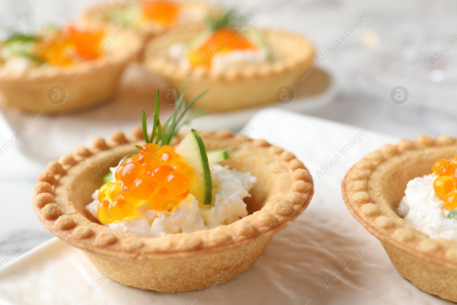 Photo of Delicious canapes with red caviar on table, closeup