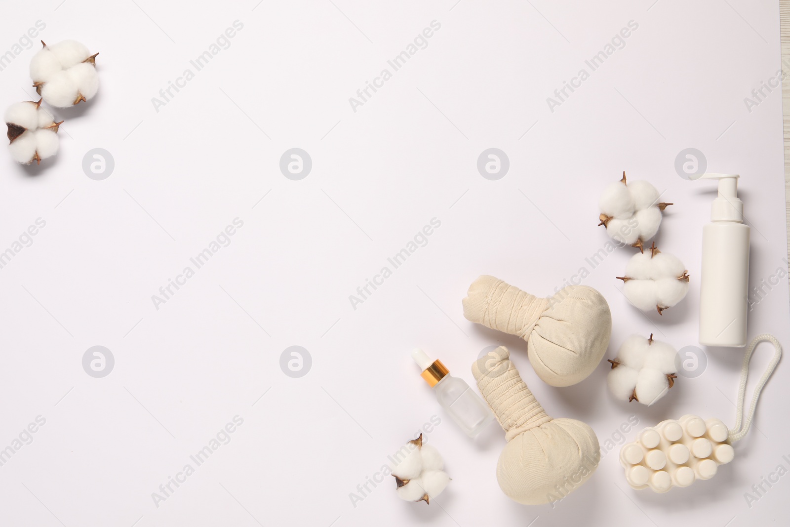 Photo of Bath accessories. Different personal care products and cotton flowers on white background, flat lay with space for text