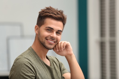 Portrait of handsome young man in room