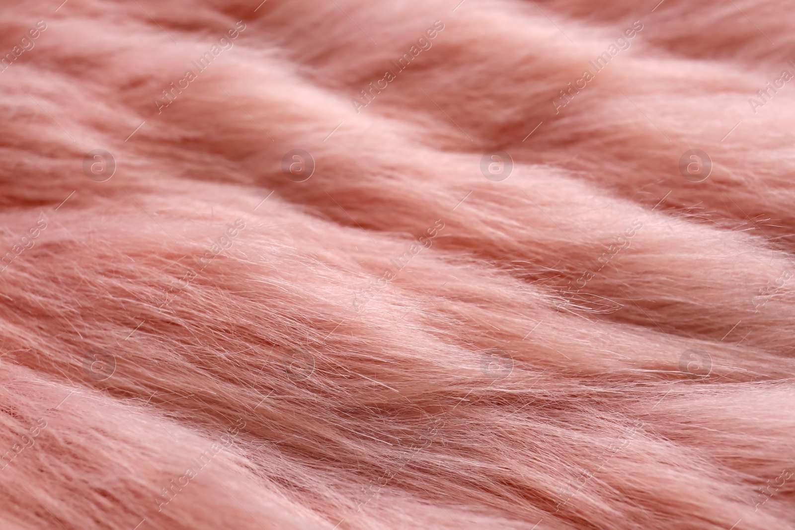 Photo of Pink faux fur as background, closeup view