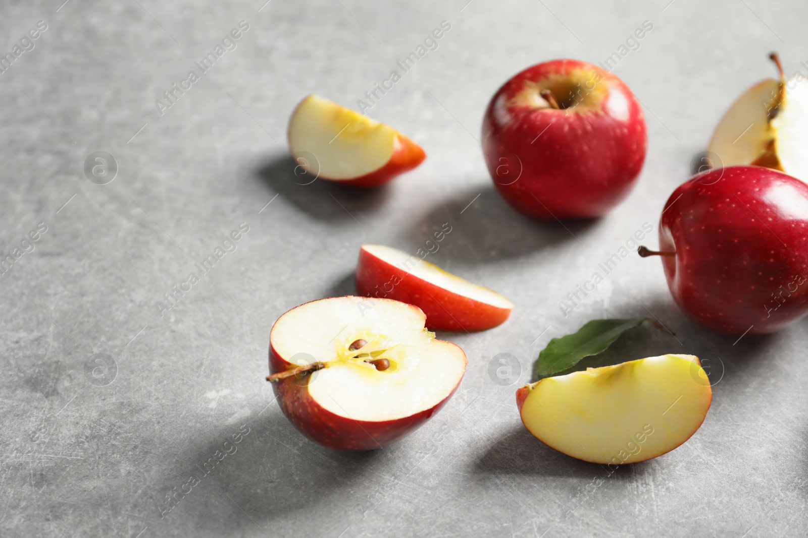 Photo of Fresh ripe red apples on light grey background