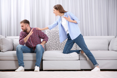 Photo of Couple having quarrel at home. Relationship problems