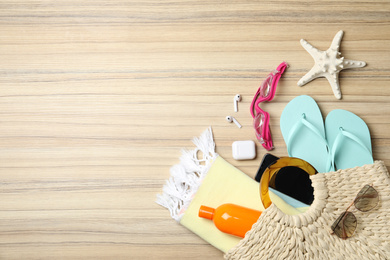 Photo of Flat lay composition with smartphone and beach objects on wooden background. Space for text