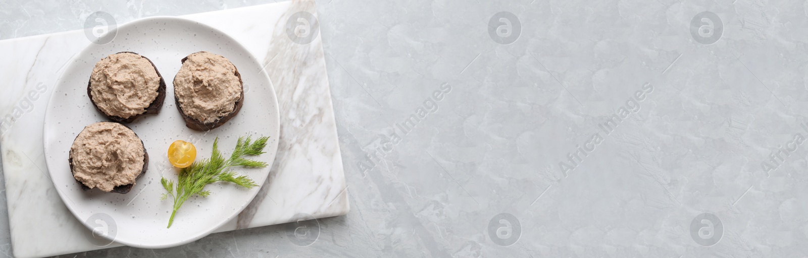 Image of Slices of bread with delicious pate served on white marble table, top view. Banner design with space for text