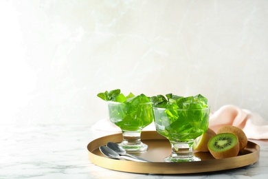 Photo of Composition with kiwi jelly in bowls on  table. Space for text