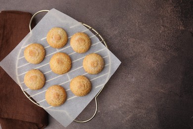 Photo of Tasty sweet sugar cookies on brown table, top view. Space for text