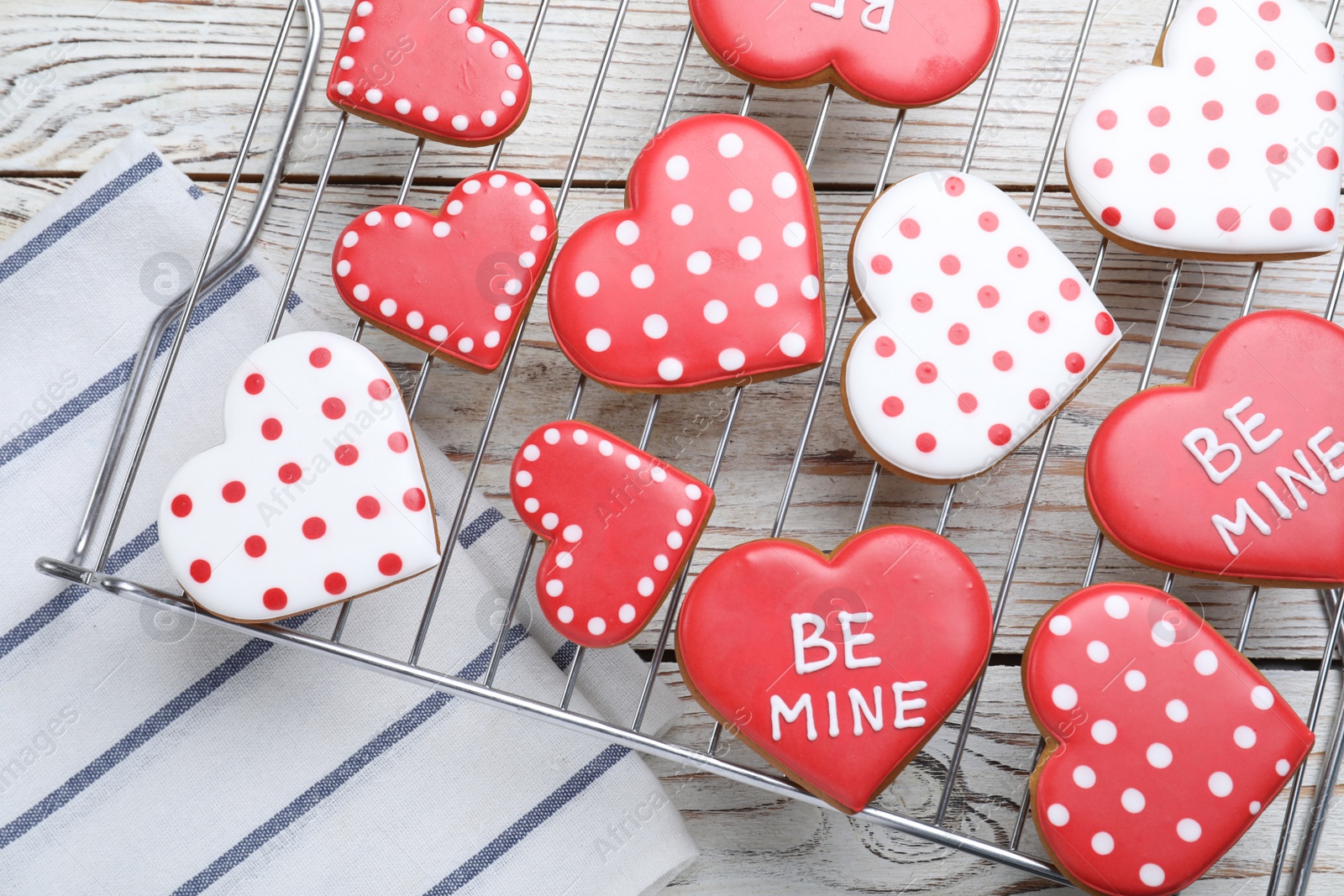 Photo of Decorated heart shaped cookies on white wooden table, flat lay. Valentine's day treat