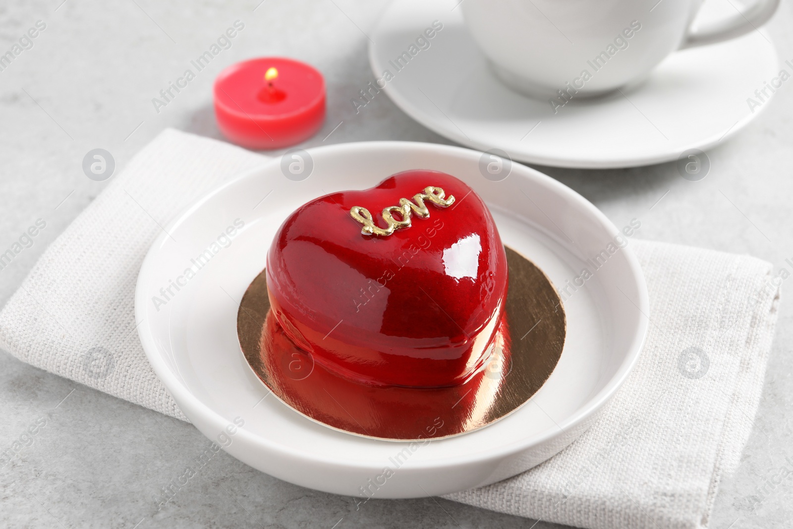 Photo of St. Valentine's Day. Delicious heart shaped cake served on light table, closeup