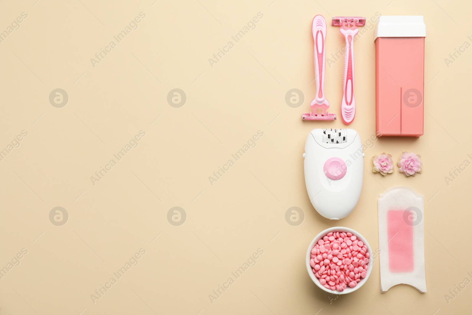 Photo of Set of epilation products on beige background, flat lay. Space for text