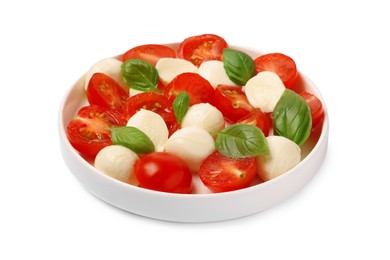 Photo of Plate of delicious Caprese salad with tomatoes, mozzarella and basil isolated on white